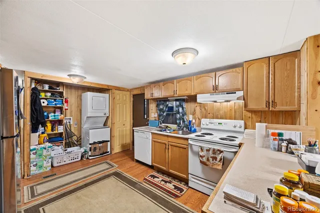 a kitchen with a stove a refrigerator and wooden cabinets