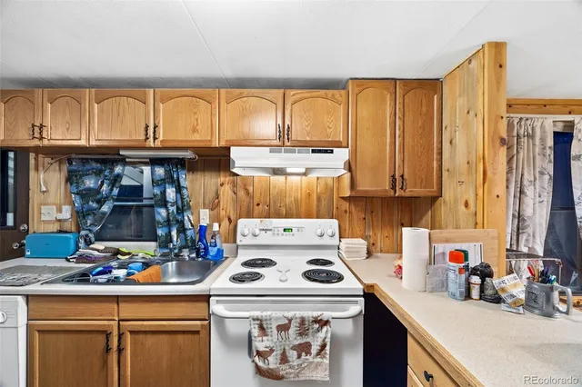 a kitchen with a stove a sink and a refrigerator