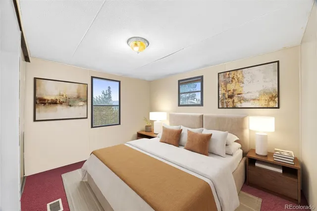 a bedroom with a bed and a painting on the wall