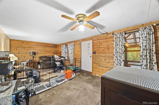 a bedroom with furniture and large window