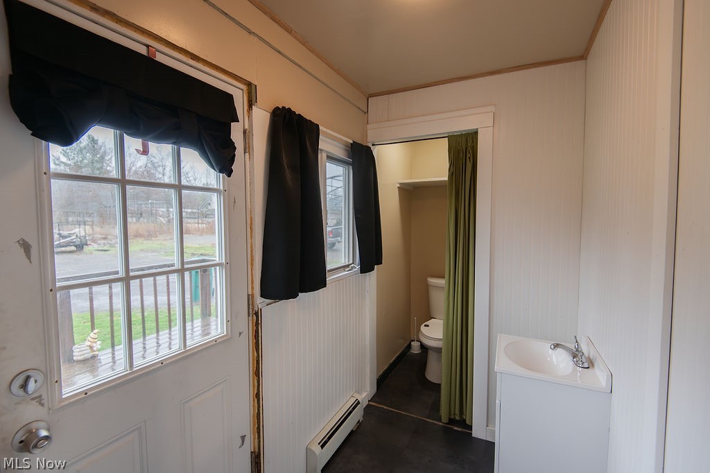 1195 South Johnson Road Sebring, OH 44672 - Photo 13 of 34 Bathroom featuring a baseboard heating unit, vanity, and crown molding