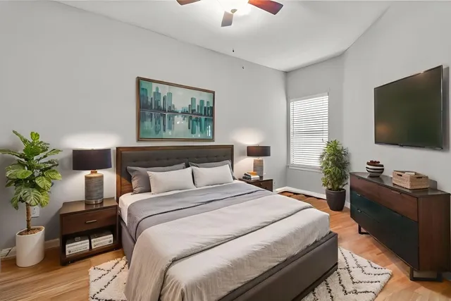 a bedroom with a bed and a potted plant