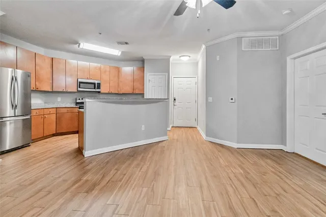 a kitchen with stainless steel appliances granite countertop a refrigerator and a sink