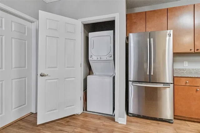 a view of a refrigerator in kitchen and white cabinets