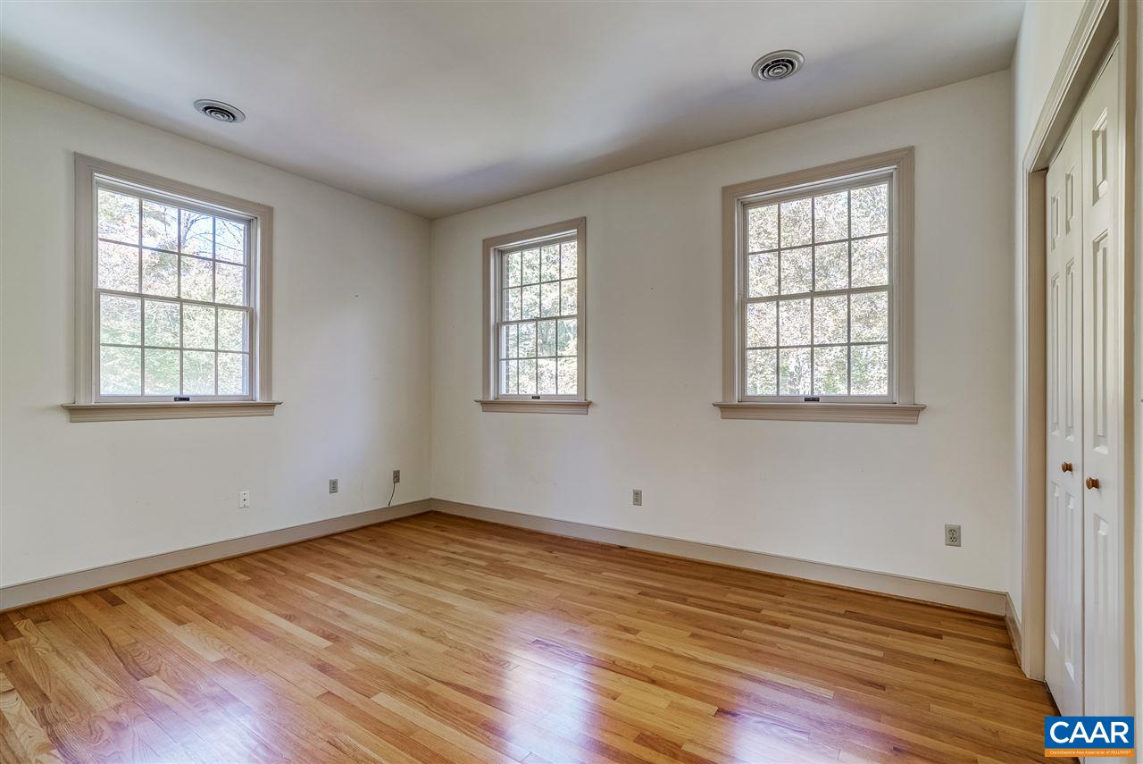130 Terrell Road East Charlottesville, VA 22901 - Photo 30 of 44 an empty room with wooden floor and windows