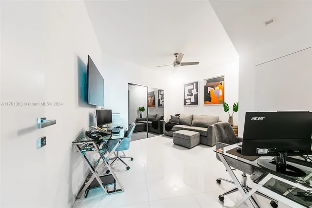 a view of a workspace with furniture and a potted plant
