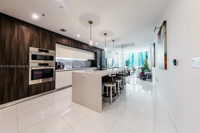 a kitchen with kitchen island wooden cabinets and stainless steel appliances