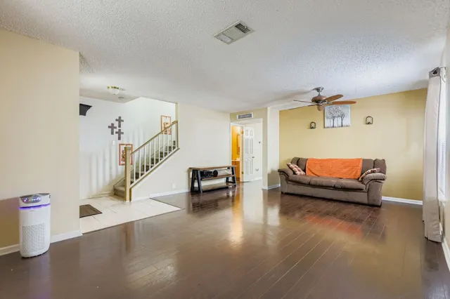 a view of livingroom with hardwood floor and ceiling fan