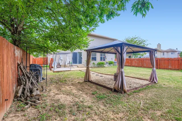 a view of a house with backyard and a patio