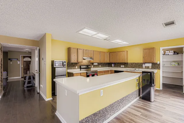 a kitchen that has a sink and a stove in it