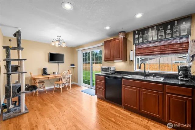 a kitchen with stainless steel appliances granite countertop a sink and cabinets
