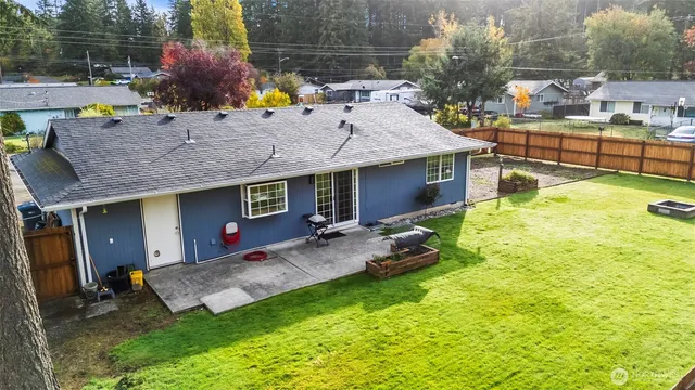a view of a house with backyard outdoor seating area and furniture