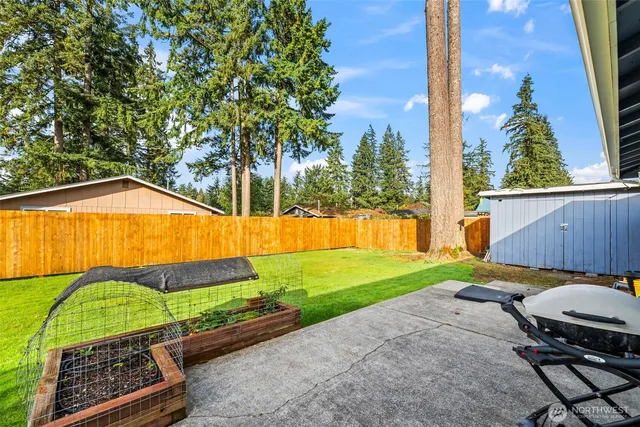 a view of backyard with swimming pool and outdoor seating