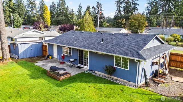 a view of a house with backyard porch and sitting area