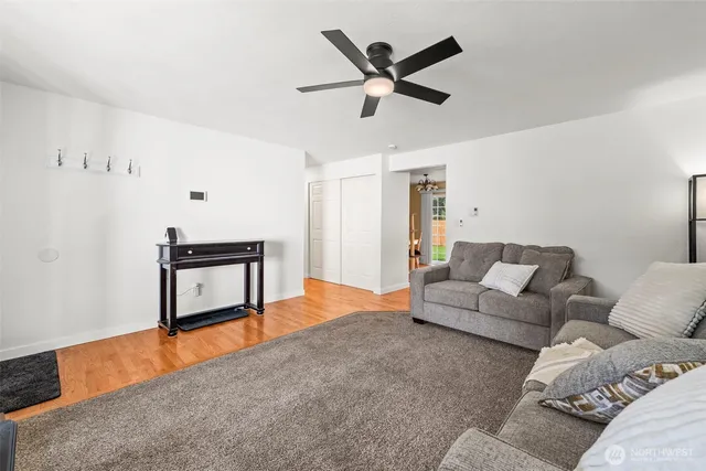 a living room with furniture and a wooden floor