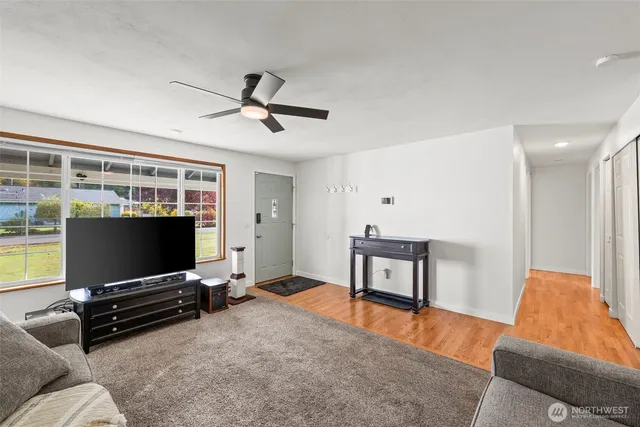 a living room with furniture and a flat screen tv