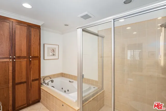 a bathroom with a tub a shower and a sink