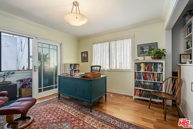 a living room with fireplace furniture and a book shelf