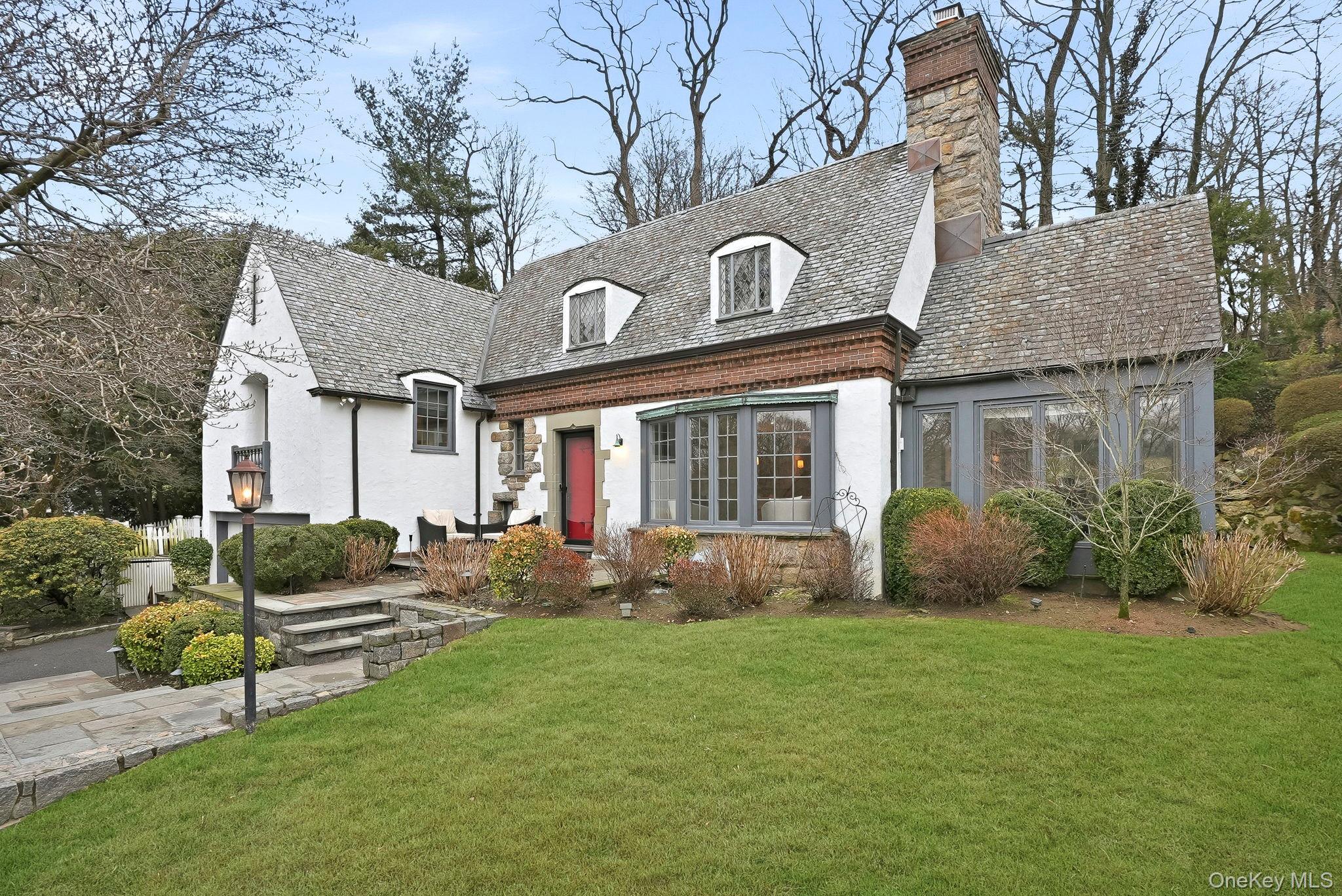 22 Taunton Road Scarsdale, NY 10583 - Photo 1 of 41 a front view of a house with garden