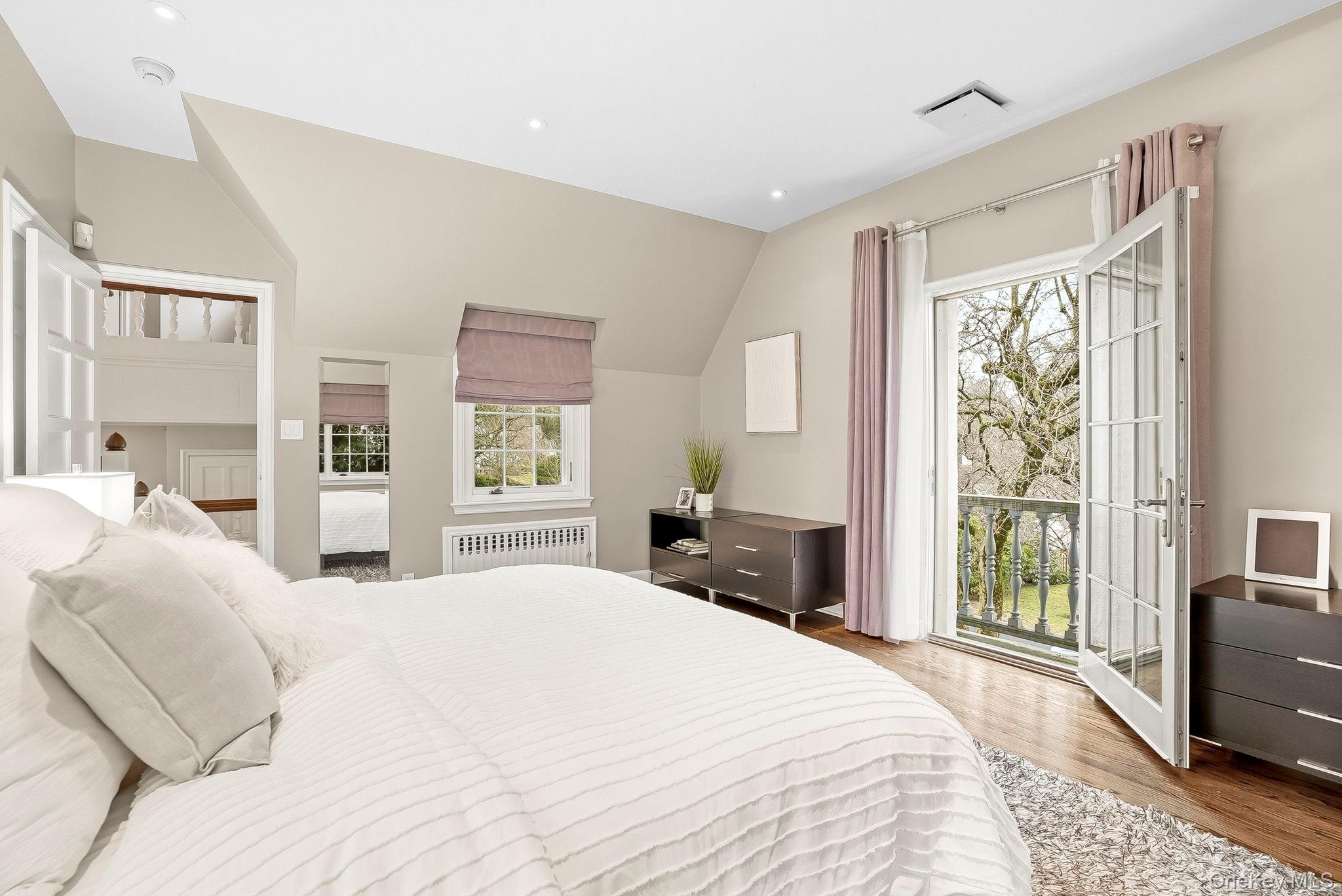 22 Taunton Road Scarsdale, NY 10583 - Photo 19 of 41 a bedroom with a large bed and a large window