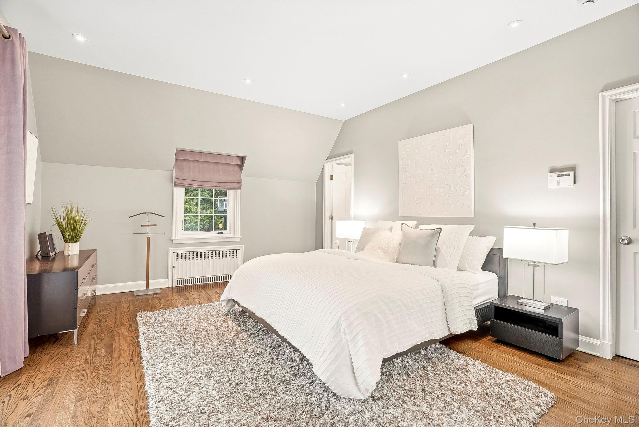 22 Taunton Road Scarsdale, NY 10583 - Photo 20 of 41 a bedroom with a bed wooden floor and a window