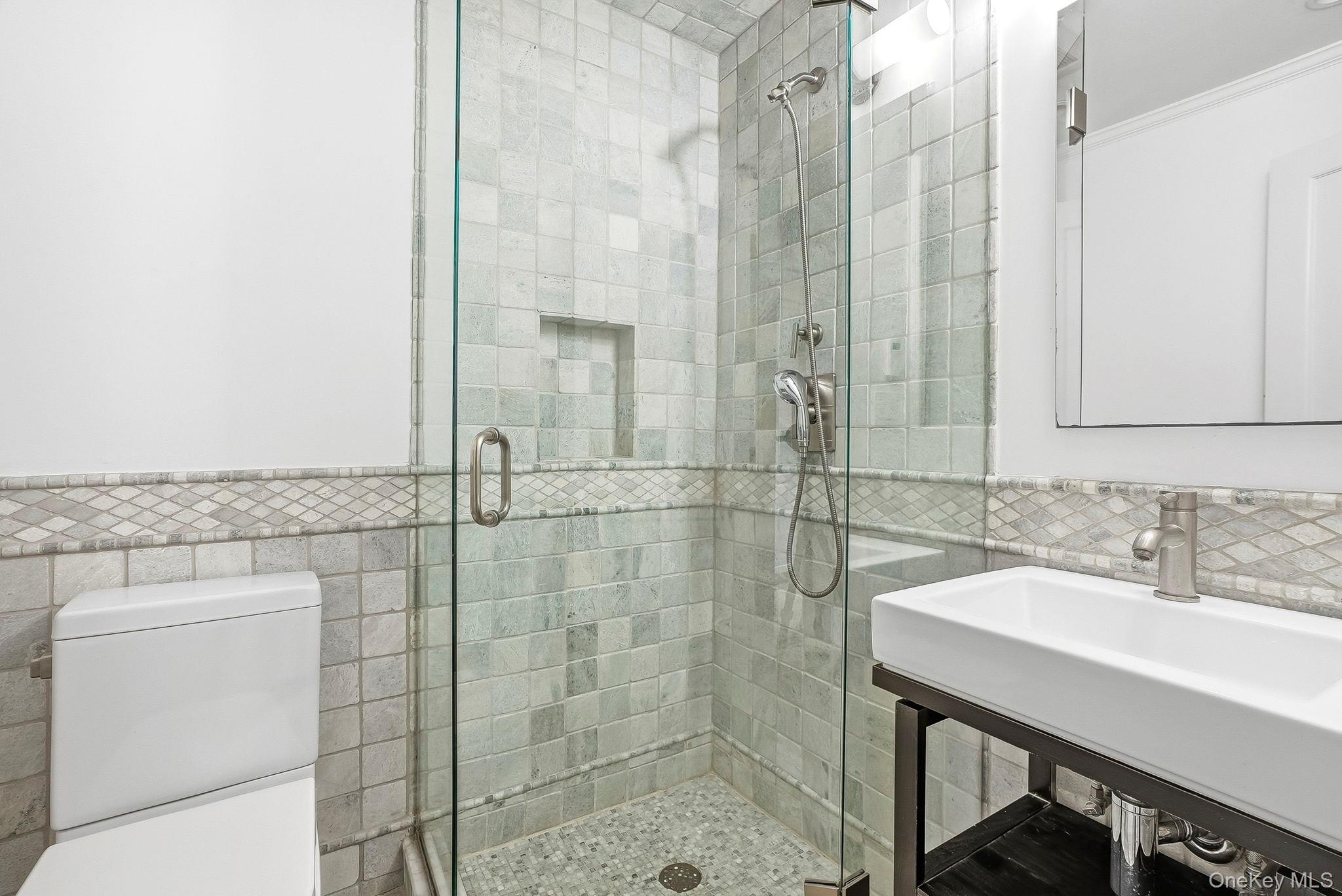 22 Taunton Road Scarsdale, NY 10583 - Photo 23 of 41 a bathroom with a sink a toilet and shower