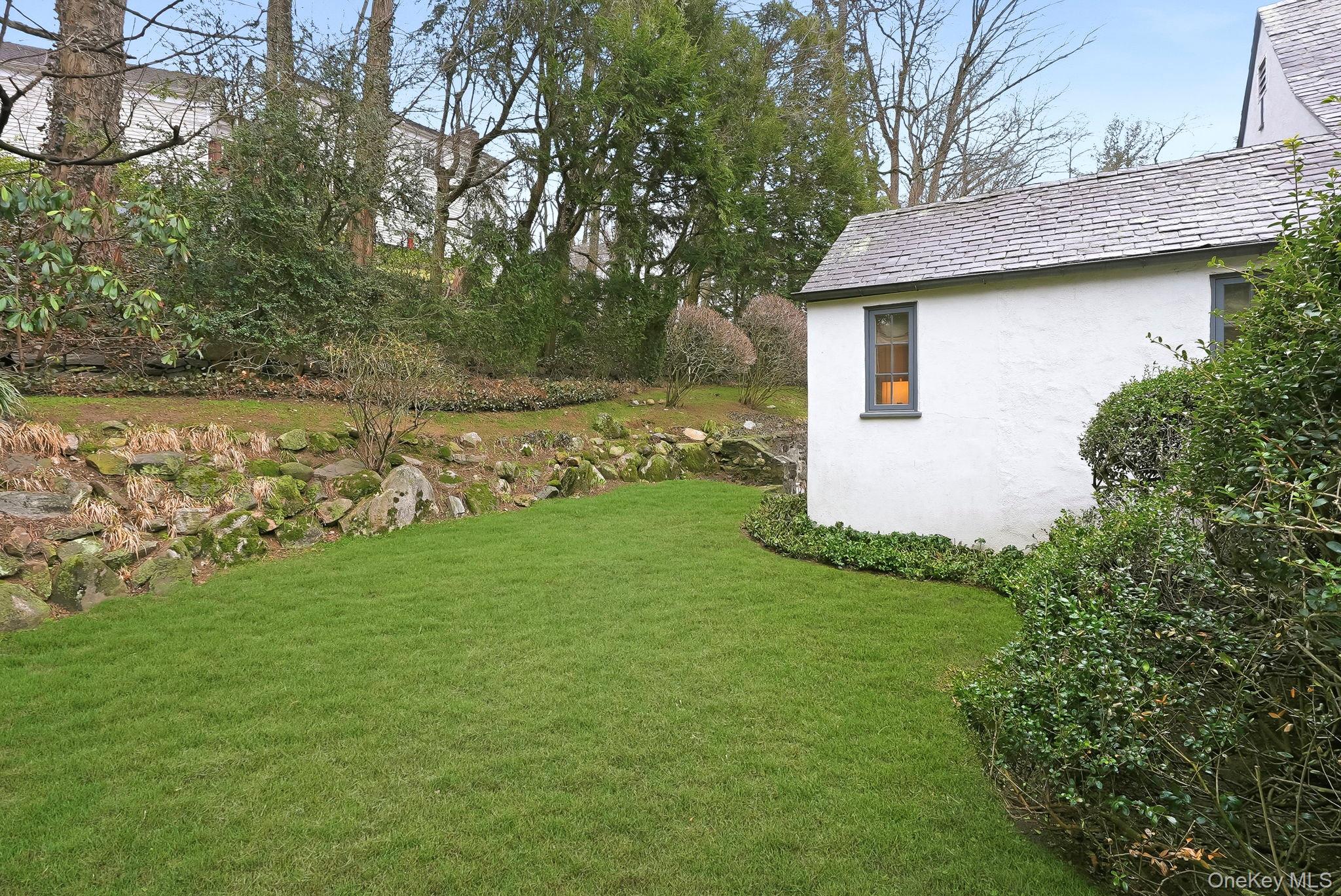22 Taunton Road Scarsdale, NY 10583 - Photo 31 of 41 a view of a backyard with plants and large trees