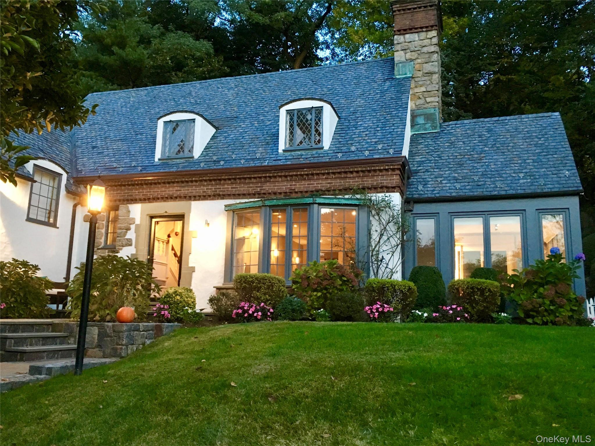 22 Taunton Road Scarsdale, NY 10583 - Photo 34 of 41 a front view of a house with garden
