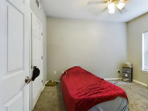 a bedroom with a bed and a chandelier