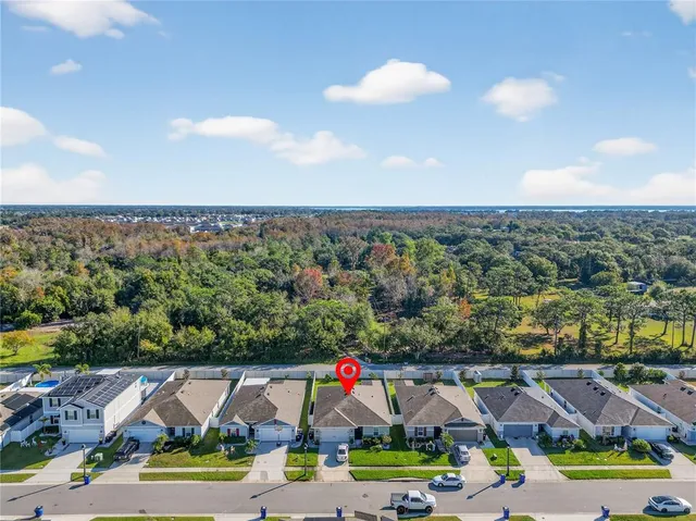 an aerial view of residential houses with outdoor space and swimming pool