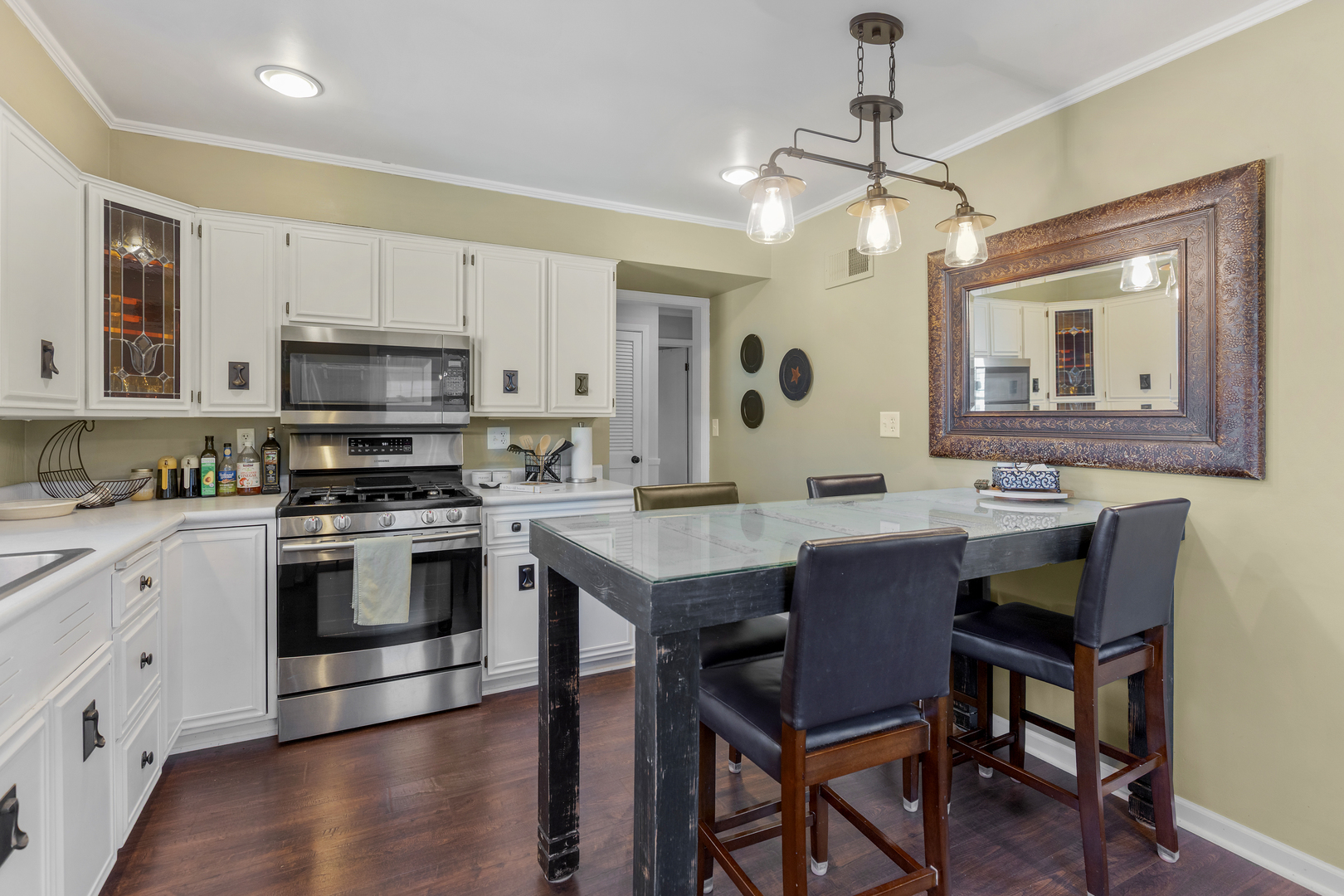 32 Jayne Street Algonquin, IL 60102 - Photo 16 of 22 a kitchen with a stove cabinets and chairs