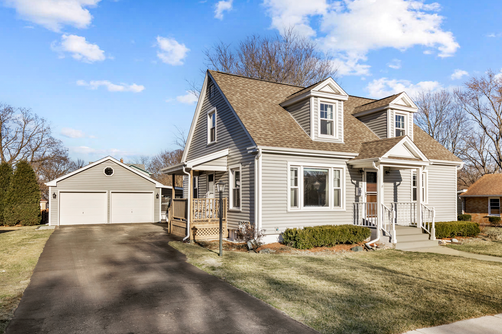 32 Jayne Street Algonquin, IL 60102 - Photo 19 of 22 a view of a white house with large windows next to a road