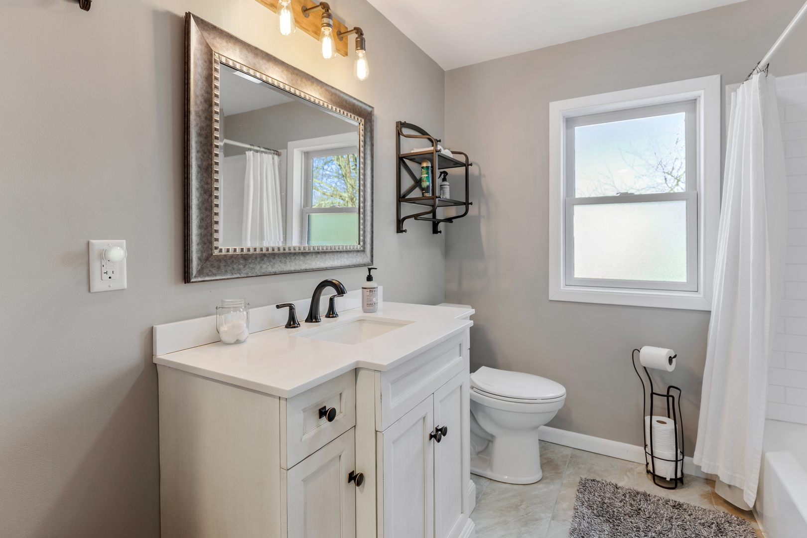 32 Jayne Street Algonquin, IL 60102 - Photo 4 of 22 a bathroom with a toilet sink and mirror