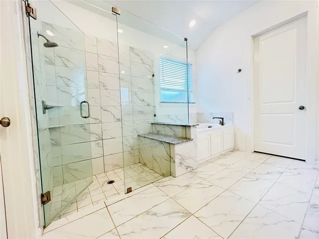 a bathroom with a bathtub and a shower