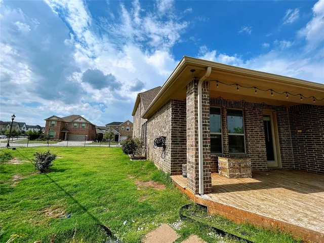 a view of a house with yard and chairs