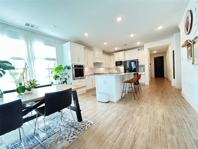 a living room filled with furniture and a kitchen