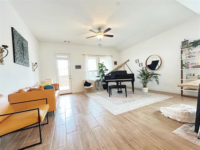 a living room with furniture and wooden floor