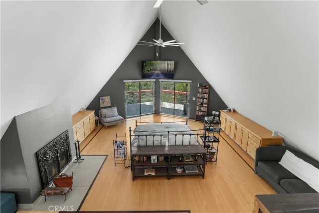 a work room with furniture a bookshelf and a window