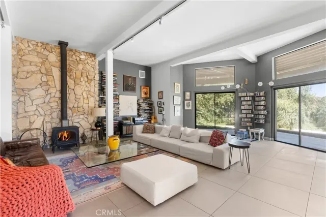 a dining room with furniture large windows and outdoor view