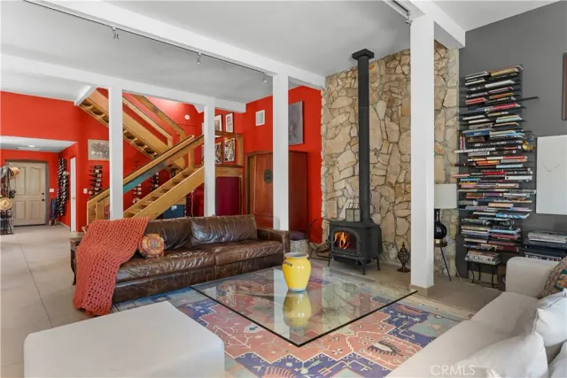 a bedroom with furniture and a staircase