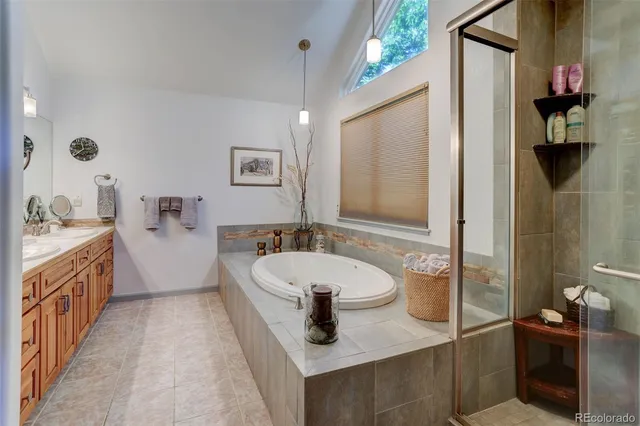 a bathroom with a granite countertop sink a toilet a mirror and shower