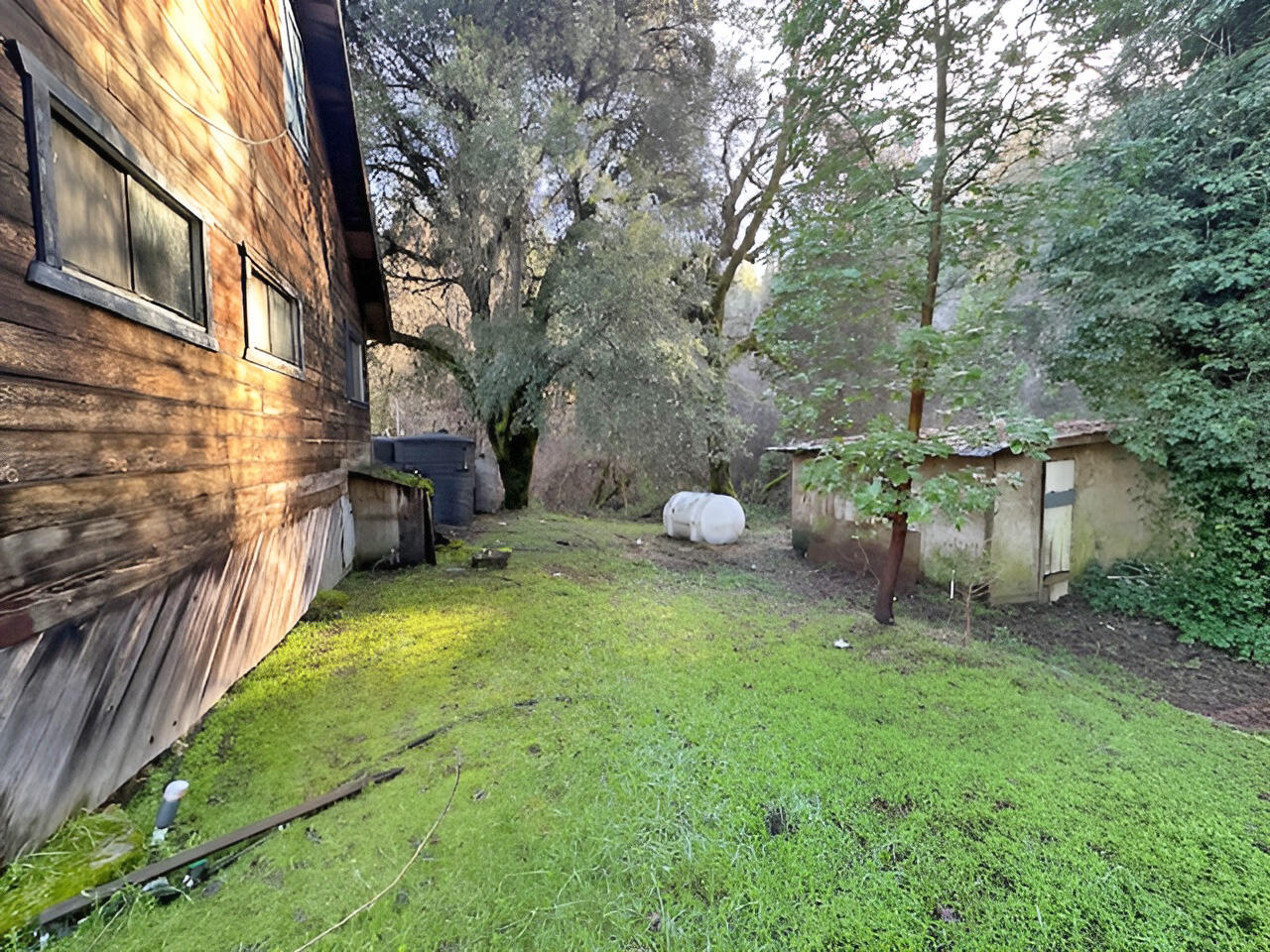 1489 Lower South Fork Road Hyampom, CA 96046 - Photo 18 of 22 a backyard of a house with table and chairs