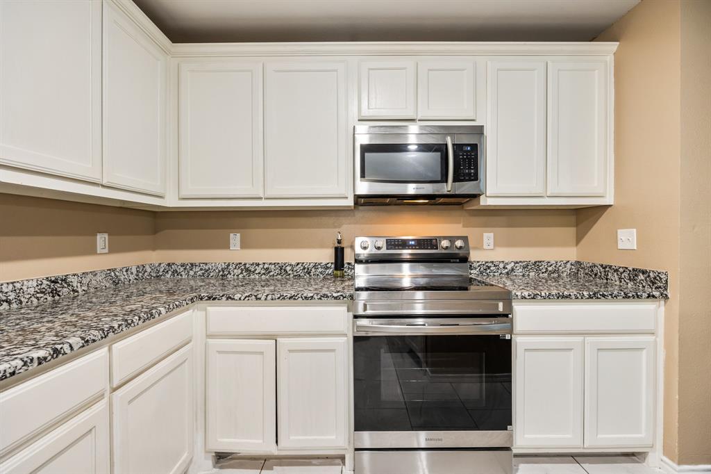 600 St Luke Street Terrell, TX 75160 - Photo 14 of 21 a kitchen with white cabinets and appliances