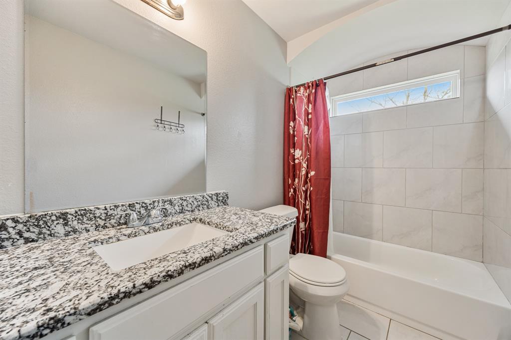 600 St Luke Street Terrell, TX 75160 - Photo 16 of 21 a bathroom with a granite countertop sink a toilet and shower
