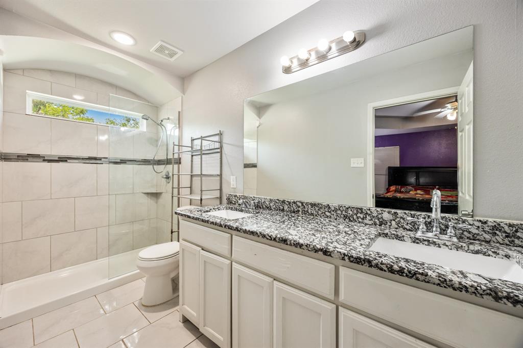 600 St Luke Street Terrell, TX 75160 - Photo 21 of 21 a bathroom with a granite countertop sink a toilet a mirror and shower