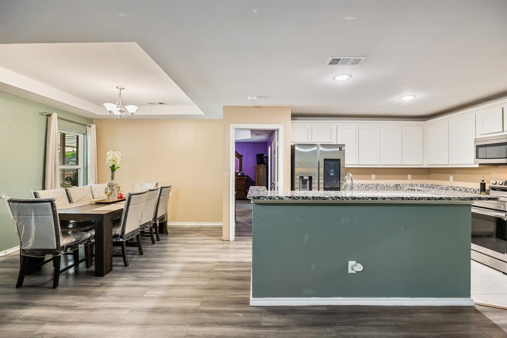 600 St Luke Street Terrell, TX 75160 - Photo 10 of 21 a kitchen with stainless steel appliances granite countertop a dining table chairs and granite counter tops