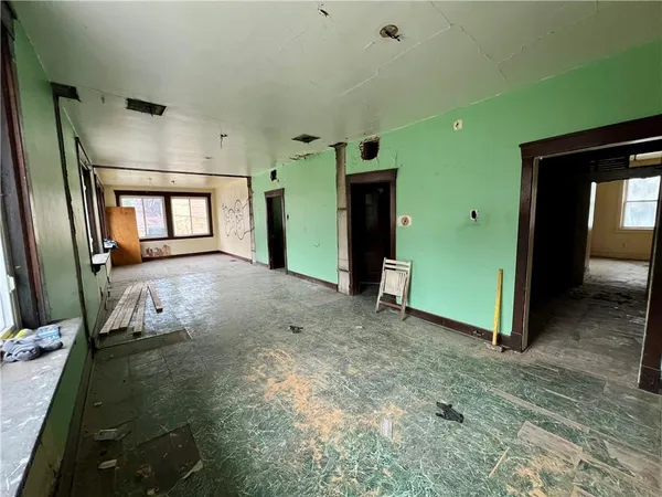 a view of a room with a fireplace and a porch