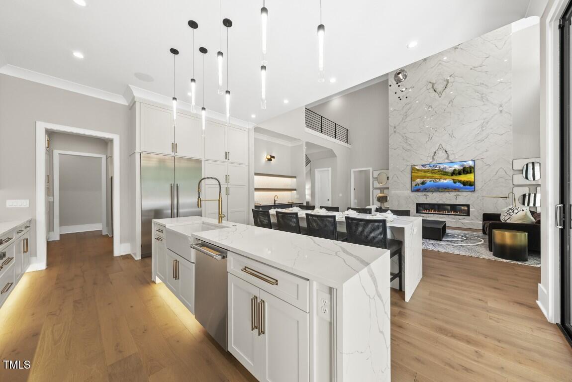 4139 Rockingham Drive Raleigh, NC 27609 - Photo 13 of 77 a large white kitchen with stainless steel appliances
