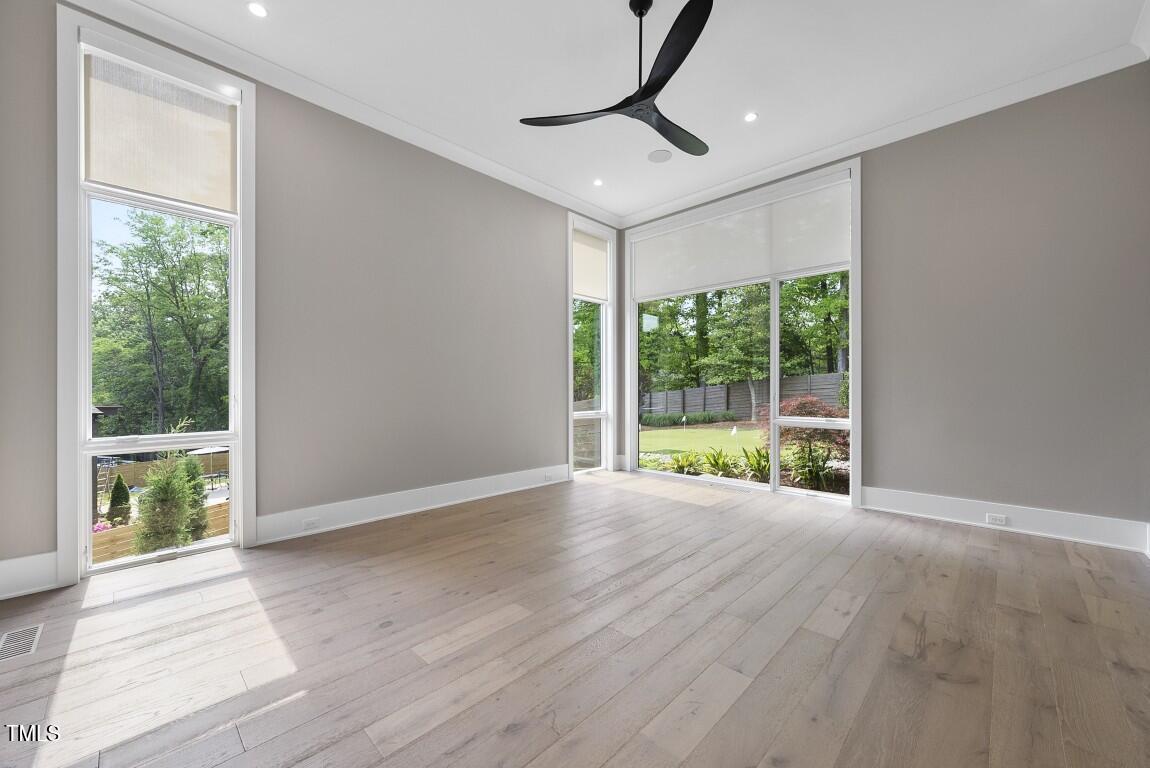 4139 Rockingham Drive Raleigh, NC 27609 - Photo 30 of 77 a view of an empty room with wooden floor and a window