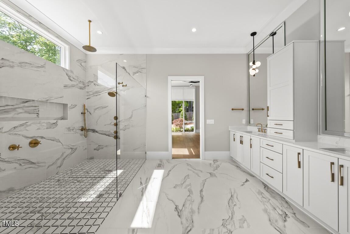 4139 Rockingham Drive Raleigh, NC 27609 - Photo 32 of 77 a spacious bathroom with a double vanity sink a mirror and shower
